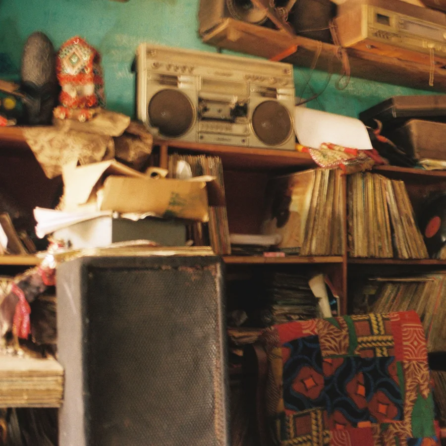 shelves of records, a boombox and a speaker in a record shop